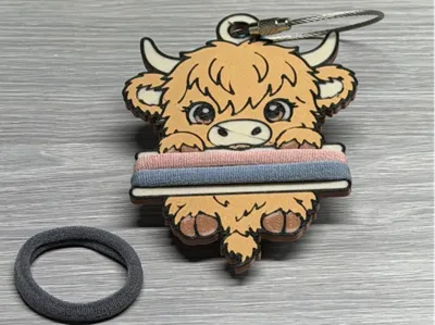 Highland cow hair tie holder with hair ties wrapped around it
